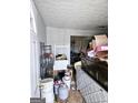 White paneled room with view to another room full of furniture and household items at 9135 Ford Sw St, Covington, GA 30014