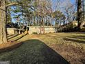 Traditional home with a large front yard, carport, and mature trees at 1380 Margarette Dr, Decatur, GA 30035