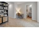 Neutral toned office space with a desk, chair, and bookshelf leading to an ensuite bathroom at 237 Ivey Ter # 41, Temple, GA 30179