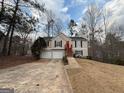 Inviting home features a two-car garage, and is surrounded by trees, offering both convenience and a touch of natural beauty at 6220 Grovener Ave, Douglasville, GA 30134