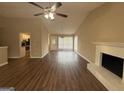 Spacious living room boasts wood floors, fireplace, abundant natural light, creating a cozy and inviting atmosphere at 6220 Grovener Ave, Douglasville, GA 30134
