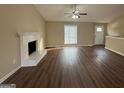Bright living room features wood floors, a cozy fireplace, and a large window for natural light, enhancing the welcoming space at 6220 Grovener Ave, Douglasville, GA 30134