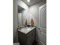 Stylish half-bath featuring a granite countertop, white sink, and modern finishes at 249 Ivey Ter # 46, Temple, GA 30179