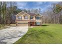 Charming two-story home with a tan exterior, a brick foundation, and a well-maintained lawn at 440 Cottonpatch Rd, Lawrenceville, GA 30046