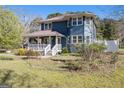 Attractive two-story home featuring a cozy front porch and a charming architectural design, surrounded by a verdant lawn at 650 Moseley Rd, Stockbridge, GA 30281