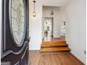 Inviting entryway with hardwood floors and decorative lighting, offering a warm welcome at 4967 Post Road Pass, Stone Mountain, GA 30088