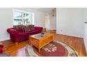 Bright living room features hardwood floors, a large window, and ample seating at 4967 Post Road Pass, Stone Mountain, GA 30088