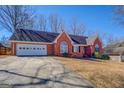 Attractive brick home featuring a two-car garage and a large paved driveway at 60 Rodney Way, Covington, GA 30016