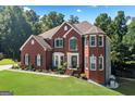 Charming brick home with manicured lawn, complemented by beautiful landscaping and a welcoming entrance at 3015 Gold Creek Dr, Villa Rica, GA 30180