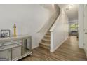 Inviting entryway features wood-look floors and stairs, leading to the upper level of the home at 11882 Fuller St, Hampton, GA 30228