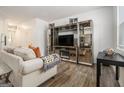 Spacious living room showcases modern furniture, stylish shelving, and natural light from a window at 11882 Fuller St, Hampton, GA 30228