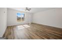 Bright living room with light-filled window and wood-look flooring at 105 Creekside Knl, Grantville, GA 30220