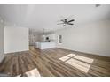 Open-concept living room featuring wood-look floors and a ceiling fan at 105 Creekside Knl, Grantville, GA 30220