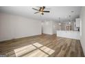Spacious living area showcasing an open layout with wood-look floors and modern lighting at 105 Creekside Knl, Grantville, GA 30220