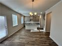 Well-lit living room featuring wood flooring and a view into the modern kitchen at 3964 Riverchess Sw Dr # 157, Atlanta, GA 30331