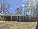 Inviting single-story home with a brick facade, covered carport and well-maintained lawn at 4572 Sahara Sw Dr, Atlanta, GA 30331