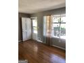 Bright living room featuring hardwood floors, natural light, and neutral wall colors at 4572 Sahara Sw Dr, Atlanta, GA 30331