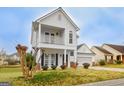 Charming two-story home featuring a welcoming front porch and attached two-car garage at 306 Turtle Pointe Dr, Carrollton, GA 30116
