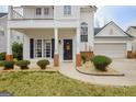 Inviting front porch with brick columns and a decorative front door at 306 Turtle Pointe Dr, Carrollton, GA 30116
