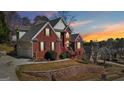 Beautiful brick home with manicured lawn, retaining wall, and lovely landscaping at 10119 Azalea Dr, Covington, GA 30014