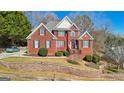 Inviting brick home with well-maintained landscaping, a welcoming porch, and great curb appeal at 10119 Azalea Dr, Covington, GA 30014