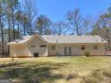 Large backyard and exterior view with manicured lawn, perfect for outdoor activities at 290 Rocky Branch Dr, Mcdonough, GA 30252