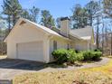 Well-maintained home featuring a side-entry garage and lush greenery at 290 Rocky Branch Dr, Mcdonough, GA 30252