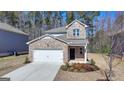 Charming brick two-story home features a manicured front yard and attached two car garage at 1659 Hay Patch Ln, Loganville, GA 30052