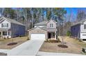 Charming brick two-story home features a manicured front yard and attached two car garage at 1659 Hay Patch Ln, Loganville, GA 30052