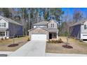 Charming brick two-story home features a manicured front yard and attached two car garage at 1659 Hay Patch Ln, Loganville, GA 30052
