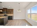 Eat-in kitchen area featuring lots of light, brown cabinets, granite countertops and stainless steel appliances at 2376 Aukerman Trce, Hampton, GA 30228