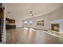 Open-concept living room featuring a cozy fireplace, wood floors, and lots of natural light at 2376 Aukerman Trce, Hampton, GA 30228
