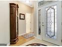 Bright foyer with tiled floors and decorative glass front door at 221 Collierstown Way, Peachtree City, GA 30269