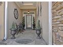Cozy front porch with decorative plants and a small table and chairs at 221 Collierstown Way, Peachtree City, GA 30269