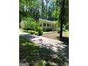 Home with a mature treeline, drive, and inviting front porch at 179 Green Valley Rd, Fayetteville, GA 30214
