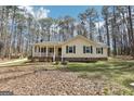 Inviting home with mature trees, a covered front porch, and classic design at 179 Green Valley Rd, Fayetteville, GA 30214