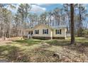 Lovely single-story home with a covered front porch, set amidst a serene wooded backdrop and lush green lawn at 179 Green Valley Rd, Fayetteville, GA 30214
