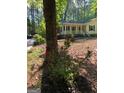 Inviting single-story home with a cozy front porch, mature trees, and landscaping at 179 Green Valley Rd, Fayetteville, GA 30214