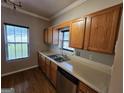 Kitchen with stainless steel appliances, hardwood floors, wood cabinets, and double sinks at 741 S Fairfield Dr, Peachtree City, GA 30269