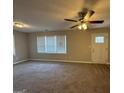 Spacious living room with neutral carpet, ceiling fan and plenty of natural light at 1643 Columbia Dr, Decatur, GA 30032