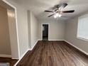 An empty living room with newly installed vinyl flooring and a modern ceiling fan at 192 Margaret St, Fairburn, GA 30213