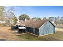 View of the back exterior showing a patio area and fenced yard at 105. Meadow Springs Ct, Locust Grove, GA 30248