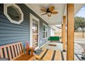 Cozy front porch with a swing and ceiling fan, creating a welcoming entrance at 105. Meadow Springs Ct, Locust Grove, GA 30248