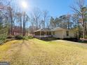 Backyard featuring a screened-in porch, a lush lawn, and mature trees providing privacy and shade at 127 Circle H Rd, Sharpsburg, GA 30277