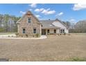 Charming home featuring stone accents, a covered porch, and beautifully landscaped front yard at 196 Old Highway 92, Fayetteville, GA 30215