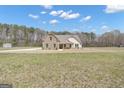 Charming home featuring stone accents, a covered porch, and spacious yard at 196 Old Highway 92, Fayetteville, GA 30215