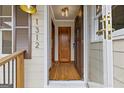 Inviting foyer featuring gleaming hardwood floors, natural light, and a classic wooden front door at 1312 Milstead Ne Ave, Conyers, GA 30012