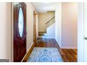 Inviting foyer features hardwood floors, a patterned rug, and a staircase at 260 Brookwood Ln, Fayetteville, GA 30215