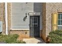 Close up of front door featuring brick and vinyl siding and manicured shrubs at 3911 Waldrop Ln, Decatur, GA 30034