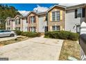 Townhouse exteriors with brick and siding, surrounded by green landscaping and concrete parking at 3911 Waldrop Ln, Decatur, GA 30034